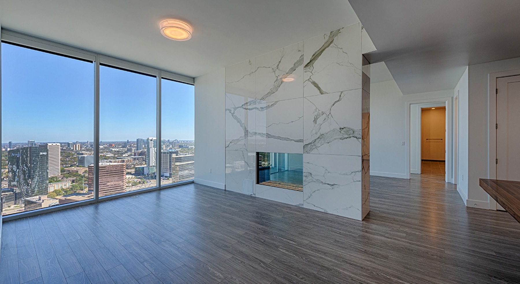 spacious and open living area with a wall for a fireplace